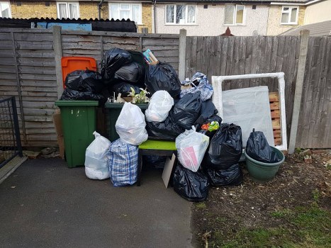 Cluttered garage before clearance in Leyton